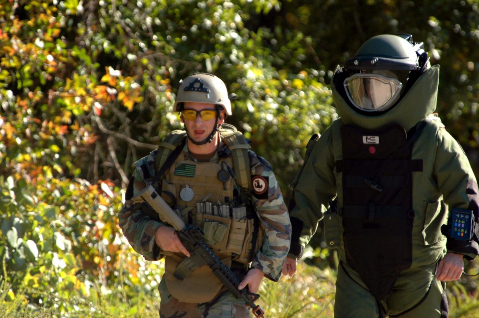 US Navy 061029-N-4515N-006 Explosive Ordnance Disposal Technician 1st Class Justin Mayo and Chief Explosive Ordnance Disposal Technician Jarrod Deines assigned to Explosive Ordnance Disposal Unit Eight (EOD-8), work as a team i
