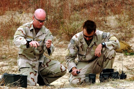 US Navy 061027-N-4515N-395 Explosive Ordnance Technician 1st Class Shane Mann and Chief Explosive Ordnance Technician Tim Spiak assigned to Explosive Ordnance Disposal Mobile Unit Two (EODMU-2), assembles an explosive charge photo