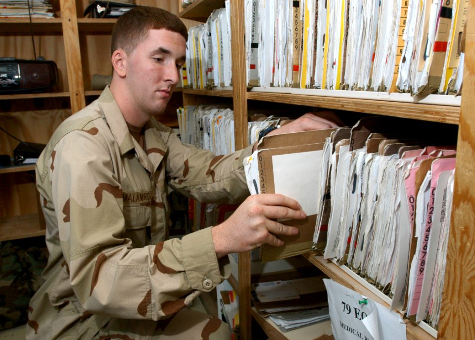 US Navy 061030-N-1328C-061 U.S. Navy Hospital Corpsman Joseph Malandro from Haddon Township, N.J., files medical records at the Michaud Medical-Dental Facility