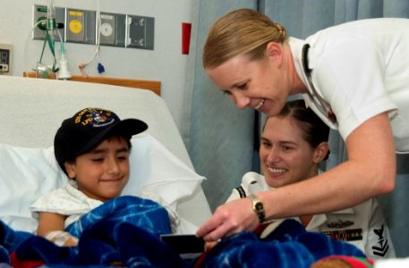 US Navy 061108-N-3750S-174 An eight year-old boy laughs with Hospital Corpsman 2nd Class April Pratt and Ensign Lisa Blachford at the Methodist Children's Hospital