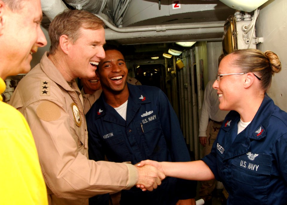 US Navy 061024-N-5928K-021 Commander Fifth Fleet, Vice Adm. Patrick Walsh, greets Mass Communication Specialist 2nd Class Molly Burgess and Machinist's Mate 2nd Class Glendon Austin during a visit to the nuclear-powered aircraf