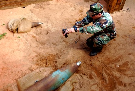 US Navy 061031-N-9769P-356 Quartermaster 2nd Class Clayton Hatton prepares an explosive charge used in rendering unexploded ordnance safe to handle photo