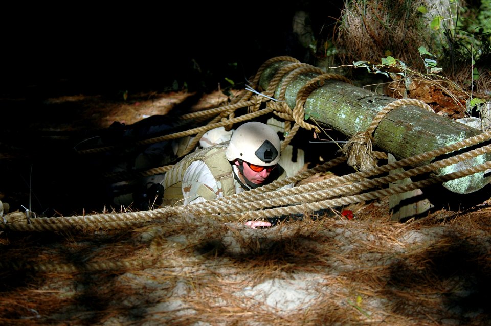 US Navy 061029-N-4515N-004 Explosive Ordnance Technician 1st Class Shane Mann from Explosive Ordnance Disposal Mobile Unit Two (EODMU-2), crawl through the obstacle course during EOD Top-Tech Challenge 2006