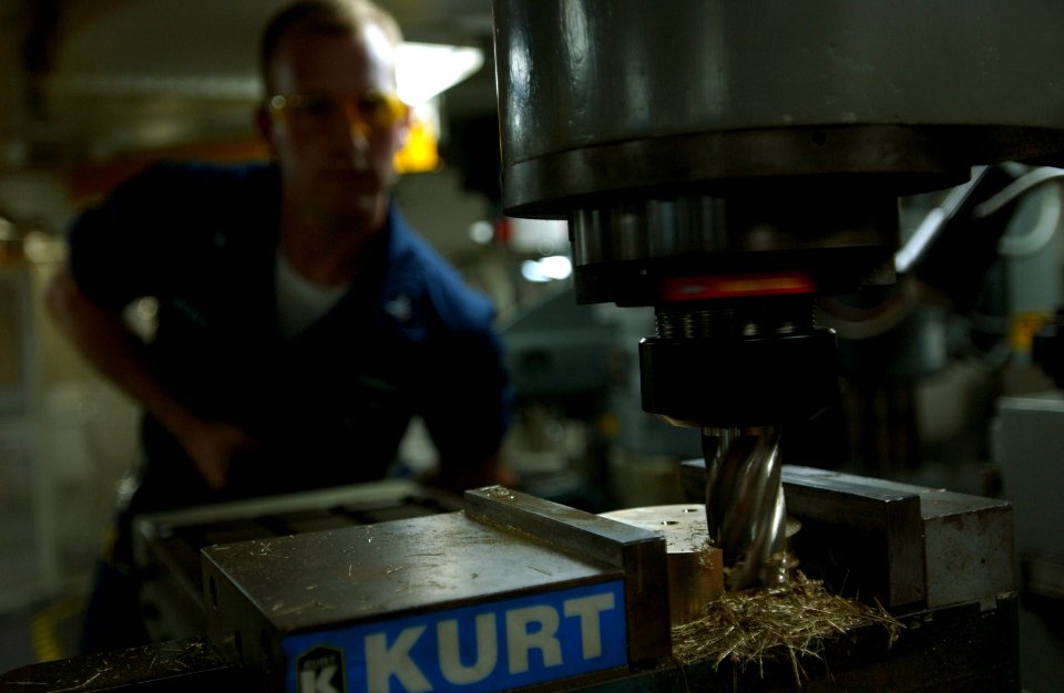 US Navy 061026-N-4133B-083 Machinery Repairman 3rd Class Kevin Weeks from San Gabriel, Calif., manufactures a clasp on a universal mill in the machine shop aboard USS Ronald Reagan (CVN 76)