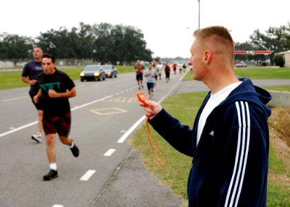 US Navy 061102-N-7427G-003 Chief Electricians Mate Aaron Niedbalski monitors the time during the 1.5 mile run portion of the Physical Fitness Assessment (PFA) held aboard Naval Air Station Joint Reserve Base New Orleans