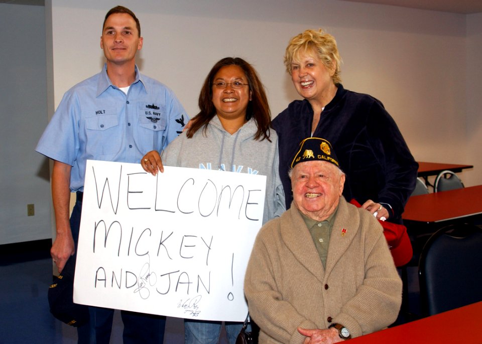 US Navy 061103-N-8102J-057 Legalman 1st Class Chris Holt and his wife takes a photo with film, stage and singing star, Mickey Rooney and his wife Jan during a visit at Mayport's United Services Organization (USO) office
