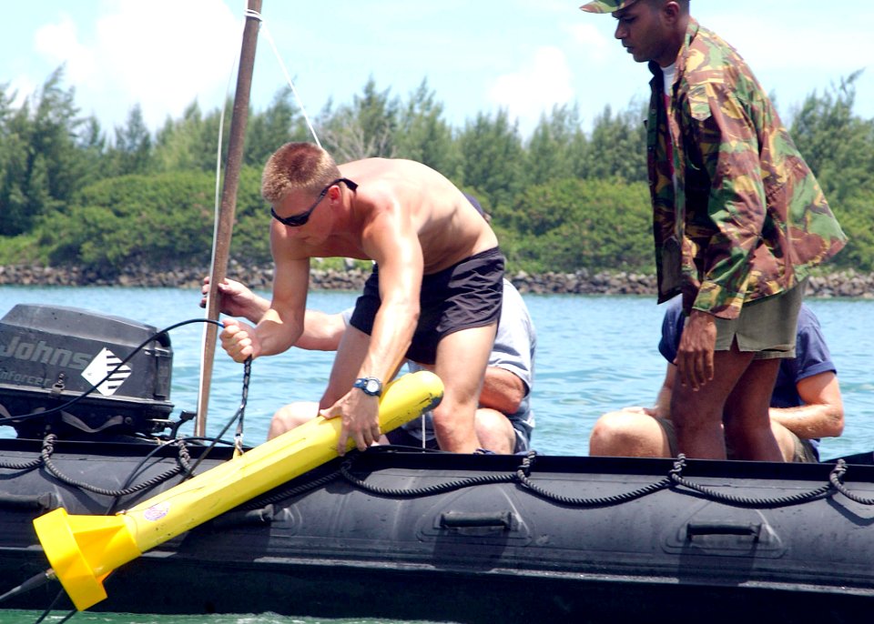 US Navy 061109-N-4205W-005 U.S. Navy Diver 2nd Class Brandon Holt, assigned to Explosive Ordnance Disposal Mobile Unit Four (EODMU-4), Det. 12, releases the tow fish for a side scan sonar