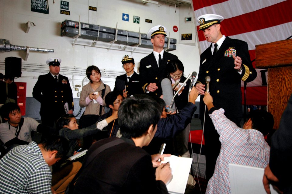 US Navy 061106-N-1332Y-252 USS Kitty Hawk (CV 63) Commanding Officer, Capt. Ed McNamee, addresses local Japanese media prior to arriving in Sasebo for a port visit