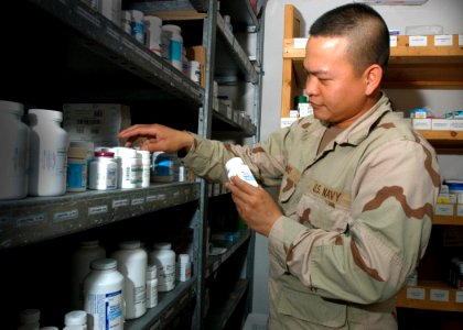 US Navy 061030-N-1328C-088 U.S. Navy Hospital Corpsman Arman Navo from Legazpi City, the Philippines, inventories medication at the Michaud Medical-Dental Facility photo