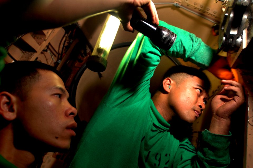 US Navy 061110-N-1332Y-427 Aviation Structural Mechanic (Equipment) 2nd Class Anthony Abraham (top), from Cebu, Philippines, and Aviation Structural Mechanic (Equipment) Airman Van Lam, from Grand Prairie, Texas, replace air du