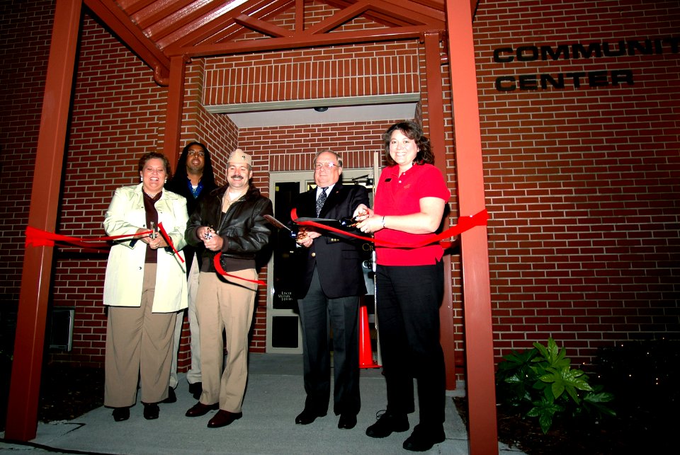 US Navy 061103-N-4515N-012 Capt. Scott Pollpeter, commanding officer, Naval Support Activity, cuts the ribbon at the reopening ceremony of the Teen Recreation Center