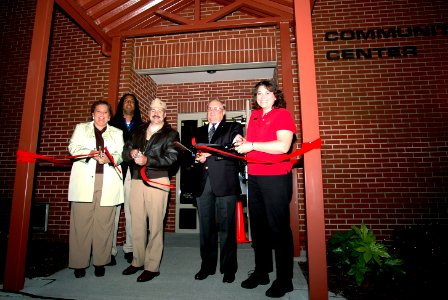 US Navy 061103-N-4515N-012 Capt. Scott Pollpeter, commanding officer, Naval Support Activity, cuts the ribbon at the reopening ceremony of the Teen Recreation Center