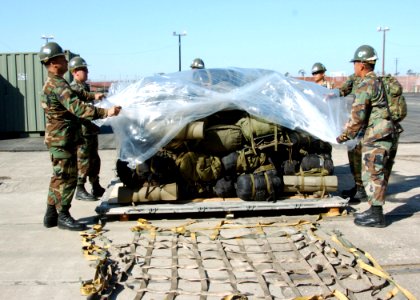 US Navy 061027-N-3560G-008 Members of Naval Mobile Construction Battalion Four (NMCB-4) load field gear onto a pallet. NMCB-4 is homeported at Ventura Naval Base, Port Hueneme, Calif