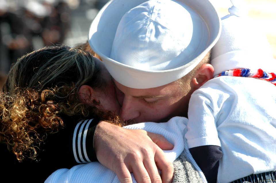 US Navy 061106-N-4515N-191 Damage Controlman 3rd Class Mark Corradi greets his family at the homecoming ceremony for the guided-missile destroyer USS Ross (DDG 71)