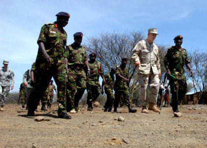 US Navy 061103-N-1328C-514 Deputy Commander of Combined Joint Task Force - Horn of Africa (JTF-HOA), U.S. Navy Rear Adm. Tim Moon (center), receives a tour from Kenyan Army Brig. Gen. Leornard Ngondi photo