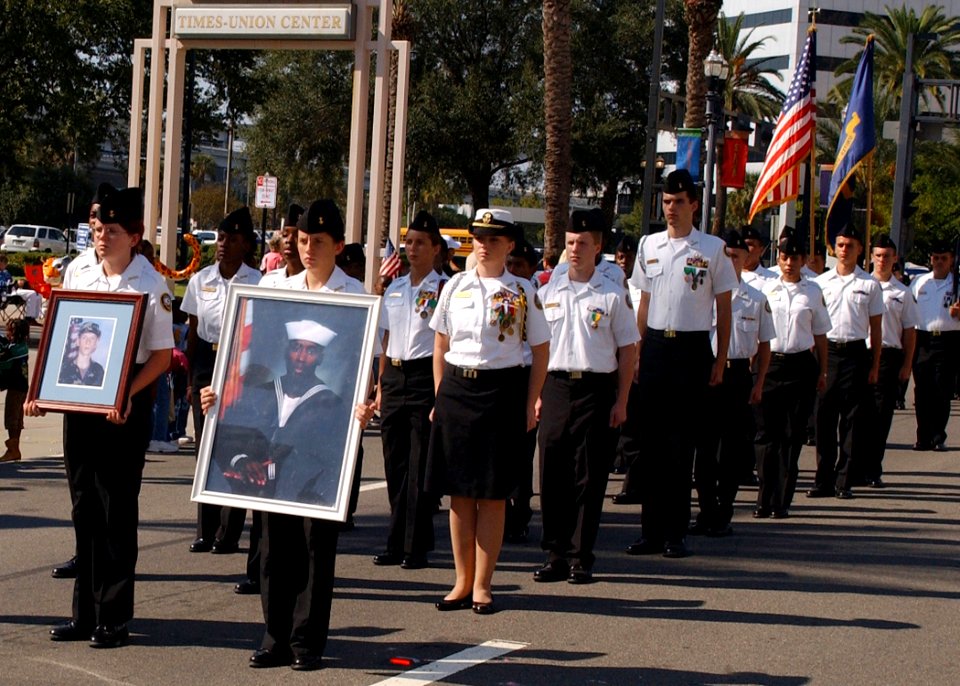 US Navy 061111-N-8544C-062 Members of the Ed White High School Naval Junior Reserve Officer Training Corps (NJROTC) carry photos of Jacksonville's Fallen Heroes, Pvt. Josh Watkins and Cpl. Isaiah Calloway, as they march through