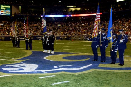 US Navy 061105-F-9032T-017 Members of the Armed Forces color guard perform during a Veteran's Day ceremony Held at the Edwards Jones Dome photo