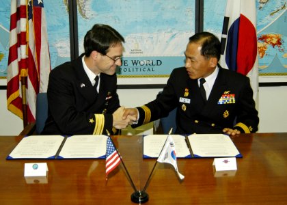 US Navy 061108-N-4649C-001 Commander, Submarine Group Seven Rear Adm. John Bird (left), shakes hands with Commander, Korean Submarine Force Rear Adm. Il Heon Bae, after signing the Mutual Logistics Support Agreement