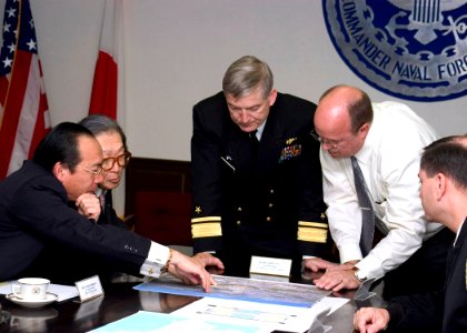 US Navy 061114-N-2716P-015 Commander Naval Forces Japan (CNFJ) Radm. James D. Kelly, center, reviews the apartment plans for a Rental Partnership Program project between CNFJ and Takara House Corporation