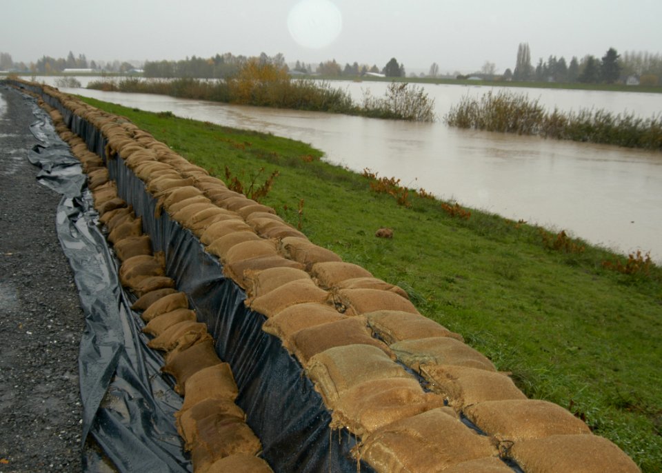 US Navy 061107-N-6247M-003 A sandbag wall, built by Sailors assigned to Naval Air Station Whidbey Island, runs along an existing dike to raise its height