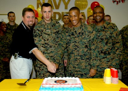 US Navy 061109-N-1082Z-005 Jeff S. Walker, Oceana Branch Navy Federal Credit Union manager, along with Pfc. Troy J. Edwards, Sgt. Wesley J. Hall and Sgt. Maj. Albert L. Stiney cut a birthday cake to commemorate the Marine Corps