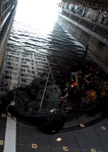 US Navy 071001-N-6710M-002 A light amphibious resupply cargo (LARC) enters the well deck of dock landing ship aboard USS Tortuga (LSD 46) while anchored off the coast of Japan photo