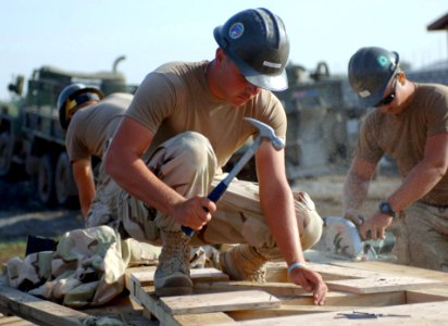 US Navy 071006-N-1003P-001 Builder Constructionman Christopher Lynch, of Naval Mobile Construction Battalion (NMCB) 40, Det. Horn of Africa (HOA), hammers nails into the roof for the Charichcho Primary School