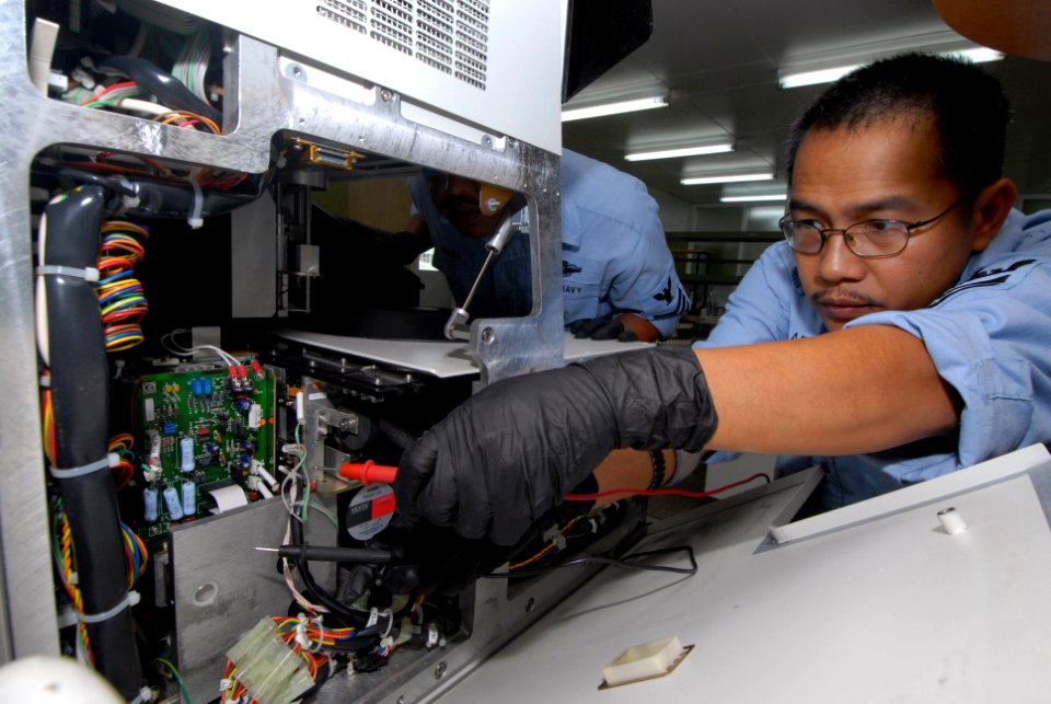US Navy 071005-N-8704K-022 Hospital Corpsman 1st Class Ervin Abalos, attached to the Military Sealift Command hospital ship USNS Comfort (T-AH 20), repairs a chemical analyzer at the Academische Hospital in Paramaribo, Suriname