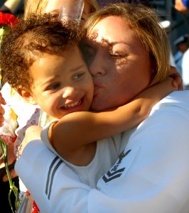 US Navy 071008-N-4163T-141 Boatswain's Mate 2nd Class Kelley Wood hugs her daughter during the homecoming celebration for guided-missile destroyer USS Milius (DDG 69)