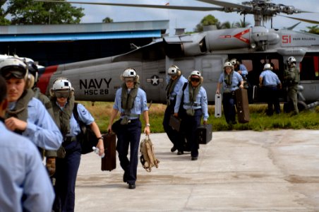 US Navy 071005-N-0194K-006 The U.S. Navy Showband, attached to the Military Sealift Command hospital ship USNS Comfort (T-AH 20), debark an MH-60S helicopter assigned to Helicopter Sea Combat (HSC) Squadron 28 photo