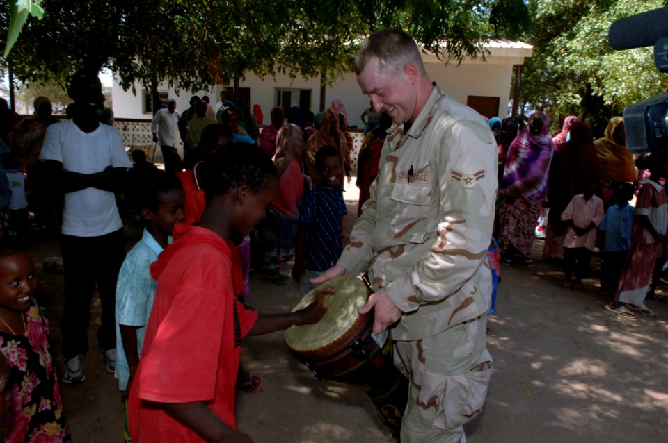 US Navy 071009-N-3931M-086 Personnel attached to Combined Joint Task Force-Horn of Africa (CJTF-HOA) and the U.S. Central Command Air Force Band interact with people from a local village following a concert performed by the ban