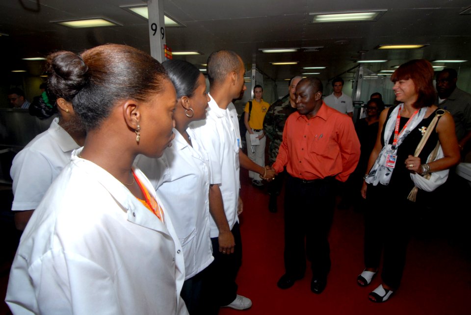 US Navy 071004-N-8704K-031 From right, Ambassador Lisa Bobbie Schreiber Hughes, U.S. ambassador to Suriname, and Michel Felisi, acting Suriname Minister of Health, greet Dutch translators during a tour of hospital ship USNS Com