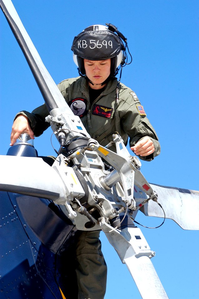 US Navy 071009-N-6410J-112 Lt. Kathryn Baehr, a pilot assigned to Helicopter Anti-Submarine Squadron Light (HSL) 49, performs a pre-flight inspection on an SH-60B Seahawk