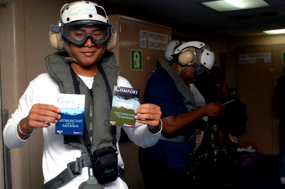US Navy 071007-N-7088A-014 Lorenzo Karta, a translator for patients who received medical care aboard the Military Sealift Command hospital ship USNS Comfort (T-AH 20), holds postcards he received prior to departing the ship by