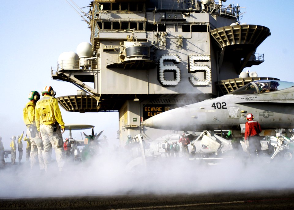 US Navy 071005-N-5681S-069 Flight deck personnel prepare to launch an F-A-18C Hornet attached to the Sidewinders of Strike Fighter Squadron (VFA) 86, from the flight deck of the nuclear-powered aircraft carrier USS Enterprise (