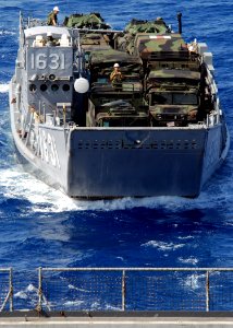 US Navy 071012-N-6710M-008 A landing craft utility prepares to enter the well deck of dock landing ship USS Tortuga (LSD 46) while transiting equipment photo