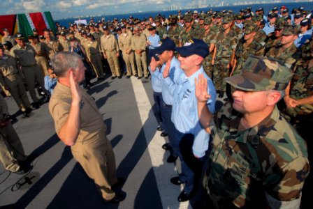 US Navy 071012-N-8704K-048 Sailors take the oath of reenlistment, administered by Chief of Naval Operations (CNO) Adm. Gary Roughead, during a welcome home ceremony aboard Military Sealift Command hospital ship USNS Comfort (T