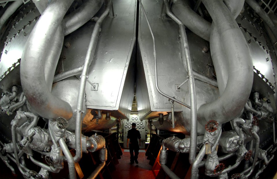 US Navy 071012-N-0194K-424 Mass Communication Specialist 3rd Class Tyler Jones walks through the engine room of Military Sealift Command hospital ship USNS Comfort (T-AH 20) while preparing for his board to earn his enlisted su