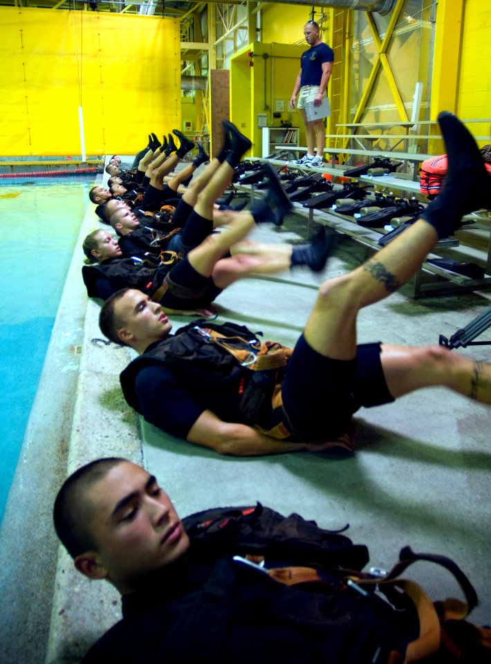US Navy 071010-N-5319A-007 Aviation Warfare Systems Operator 2nd Class Roger Richards directs Rescue Swimmer School candidates in morning physical training at Naval Air Station Pensacola