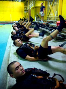 US Navy 071010-N-5319A-007 Aviation Warfare Systems Operator 2nd Class Roger Richards directs Rescue Swimmer School candidates in morning physical training at Naval Air Station Pensacola