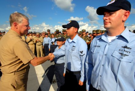 US Navy 071012-N-8704K-061 Adm. Gary Roughead congratulates Sailors after a reenlistment ceremony aboard USNS Comfort photo