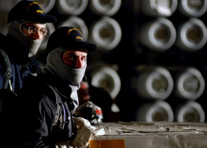 US Navy 071016-N-7981E-092 Members of air department stand fire watch in the hangar bay of Nimitz-class aircraft carrier USS Abraham Lincoln (CVN 72) during an ordnance onload at Naval Magazine Indian Island photo