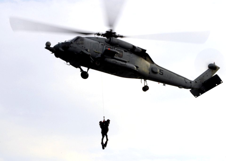 US Navy 071015-N-2638R-010 Two search and rescue (SAR) swimmers, assigned to the Chargers' of Helicopter Anti-Submarine Squadron (HS) 14, are hoisted into an HH-60H Seahawk during SAR training at Fleet Activities Y