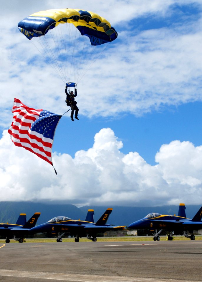 US Navy 071014-N-5476H-156 A member of the U.S. Navy Parachute Demonstration Team, the Leap Frogs, prepares for a patriotic landing during the Blues on the Bay Air Show at Marine Corps Base Hawaii