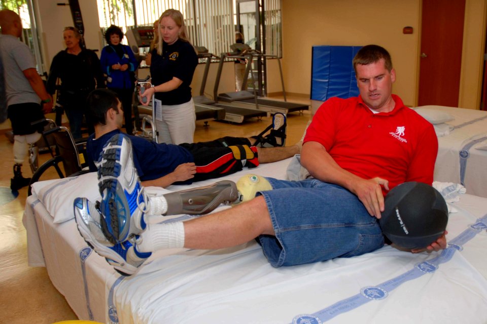 US Navy 071012-N-5086M-014 Coast Guard Fireman Brice A. Brokaw uses the medicine ball for abdominal training during therapy in the new Comprehensive Combat and Complex Casualty Care (C5) facility at Naval Medical Center San Die