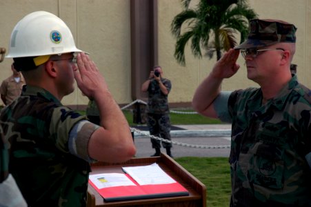 US Navy 071012-N-7367K-023 Lt. Cmdr. Michael Mihaly, left, the Guam detachment officer-in-charge for U.S. Naval Mobile Construction Battalion (NMCB) 1, accepts command over Camp Covington from Lt. Cmdr. Kemit Spears, the execut photo