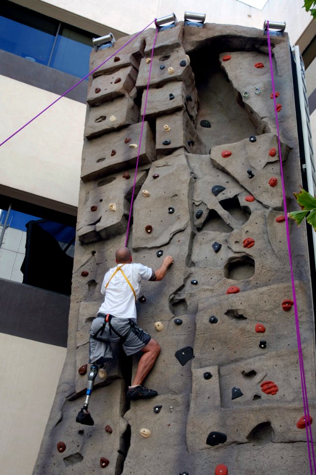US Navy 071015-N-5086M-074 U.S. Marine Corps Sgt. Jordan Pierson climbs the 30-foot rock-climbing wall during a therapy session in the new Comprehensive Combat and Complex Casualty Care (C5) facility