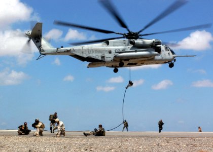 US Navy 071022-F-6318R-083 Explosive ordnance disposal technicians from Combined Joint Task Force-Horn of Africa train with French naval special forces during a hostile situation training scenario using a CH-53E Super Stallion photo