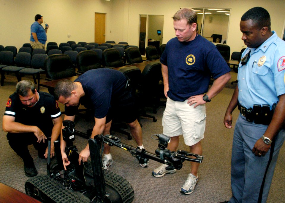 US Navy 071019-N-5208T-002 Members of Explosive Ordnance Disposal Mobile Unit (EODMU) 2, show off Talon their robot counterpart to members of the Raleigh Police Bomb Squad