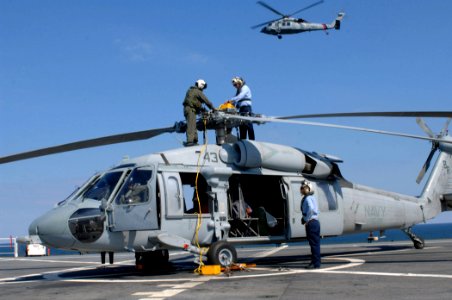 US Navy 071014-N-7088A-065 Members attached to Helicopter Sea Combat Squadron (HSC) 28, secure the propeller on an MH-60S Seahawk aboard Military Sealift Command hospital ship USNS Comfort (T-AH 20) photo